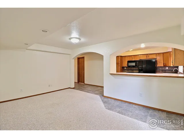 a view of a living room with a sink and a mirror
