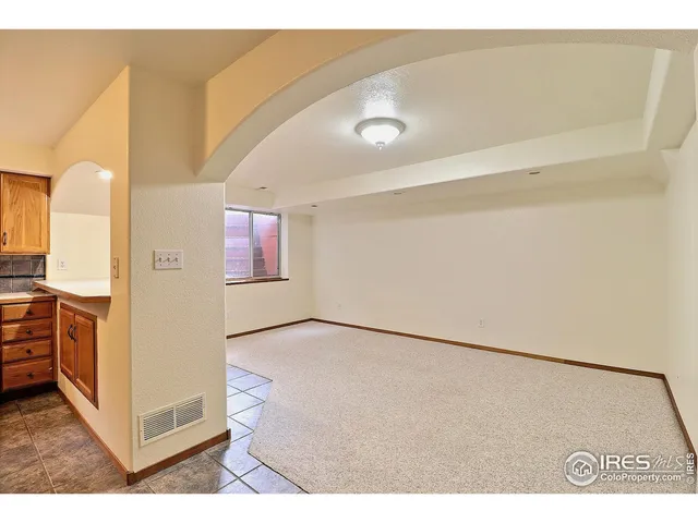a kitchen with granite countertop a sink stainless steel appliances and cabinets