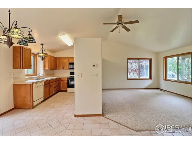 a view of a kitchen with a sink and a window