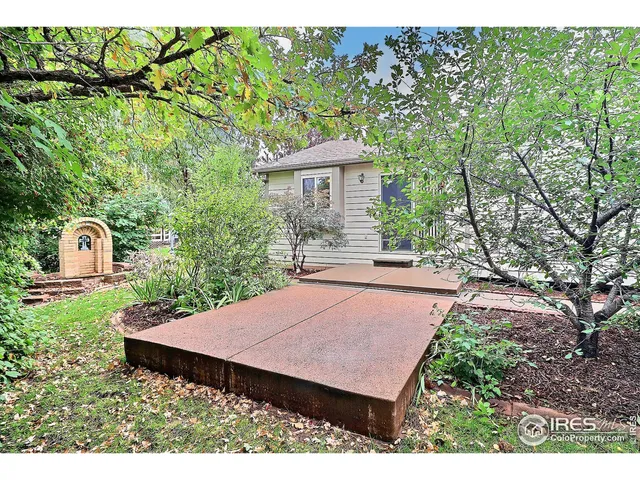 a view of a field of grass and trees