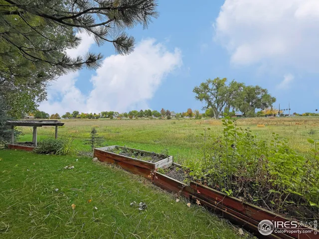 a view of a house with a big yard and sitting area
