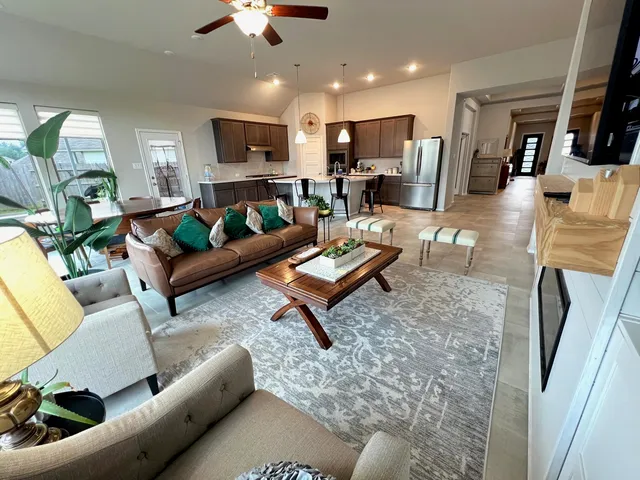 a living room with furniture fireplace and a flat screen tv