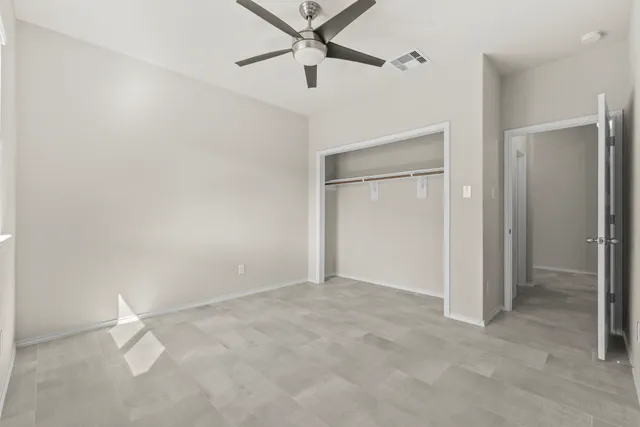 a bedroom with a bed couch and a window