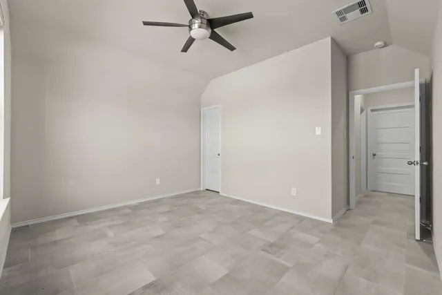 a bedroom with a bed gym equipment and a large window