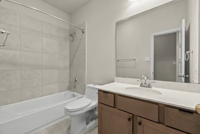a view of a room with wooden floor and ceiling fan