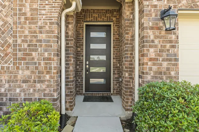 a view of a door of a house with potted plants