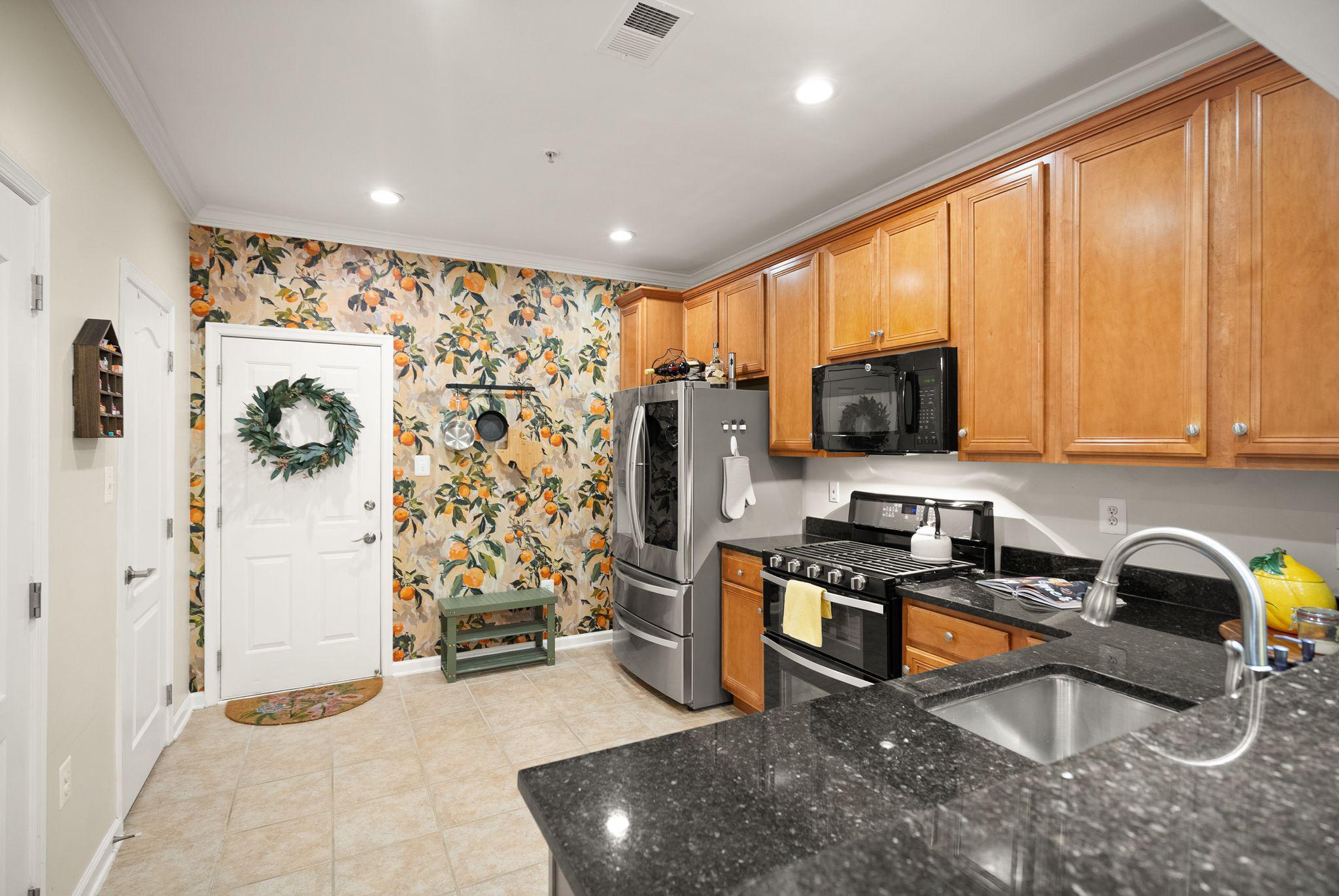 12414 A Liberty Bridge Road Fairfax, VA 22033 - Photo 9 of 38 a kitchen with stainless steel appliances granite countertop a refrigerator a stove top oven a sink and dishwasher
