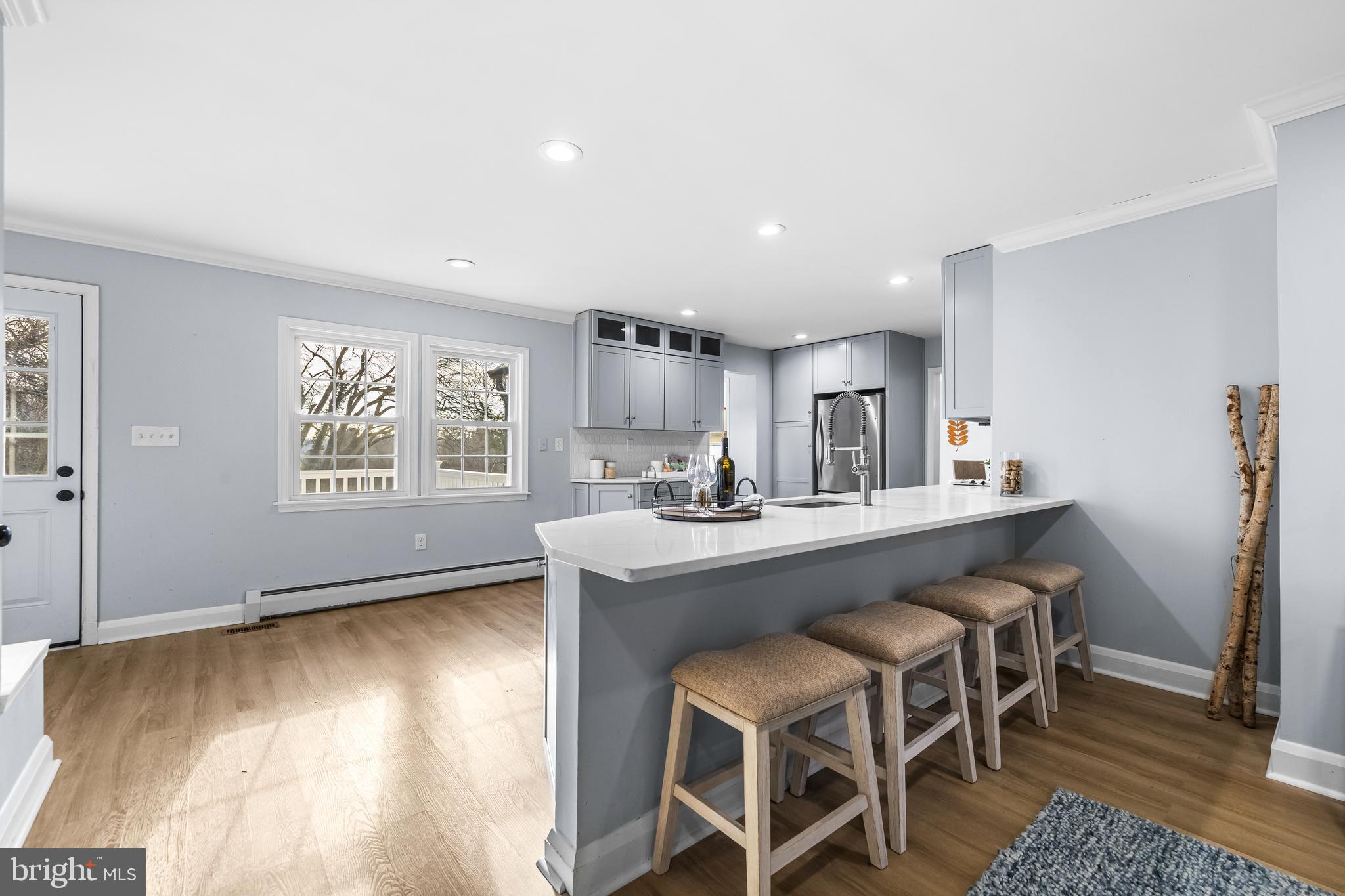 3533 Stansbury Mill Road Phoenix, MD 21131 - Photo 12 of 47 a kitchen with kitchen island a sink table and chairs