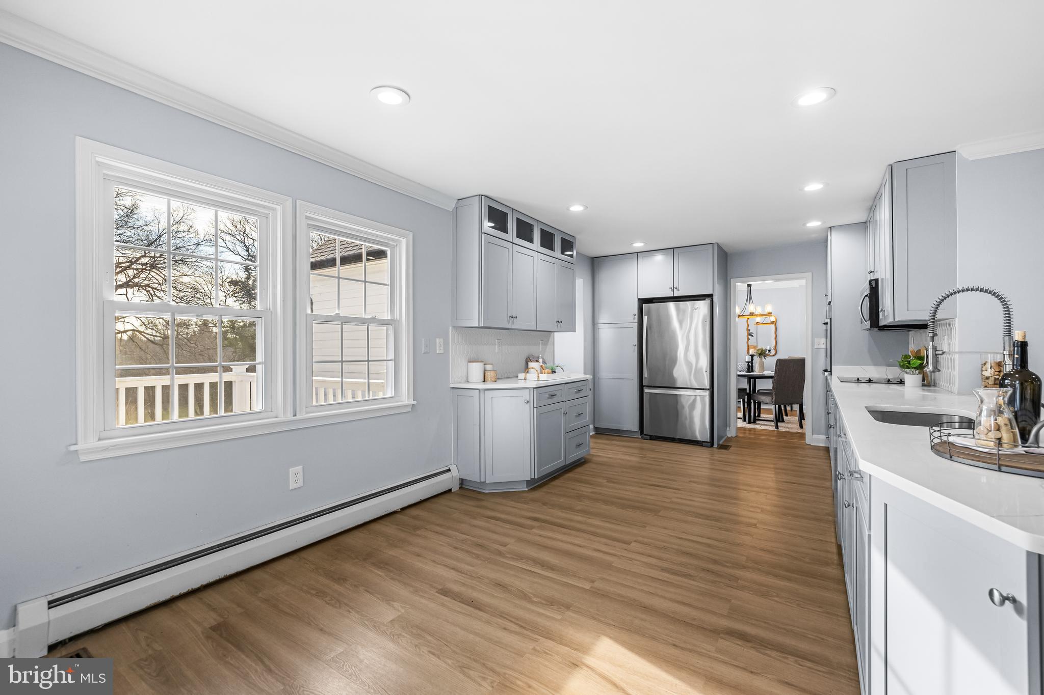 3533 Stansbury Mill Road Phoenix, MD 21131 - Photo 13 of 47 a large kitchen with stainless steel appliances granite countertop a large counter top a sink a refrigerator and a window