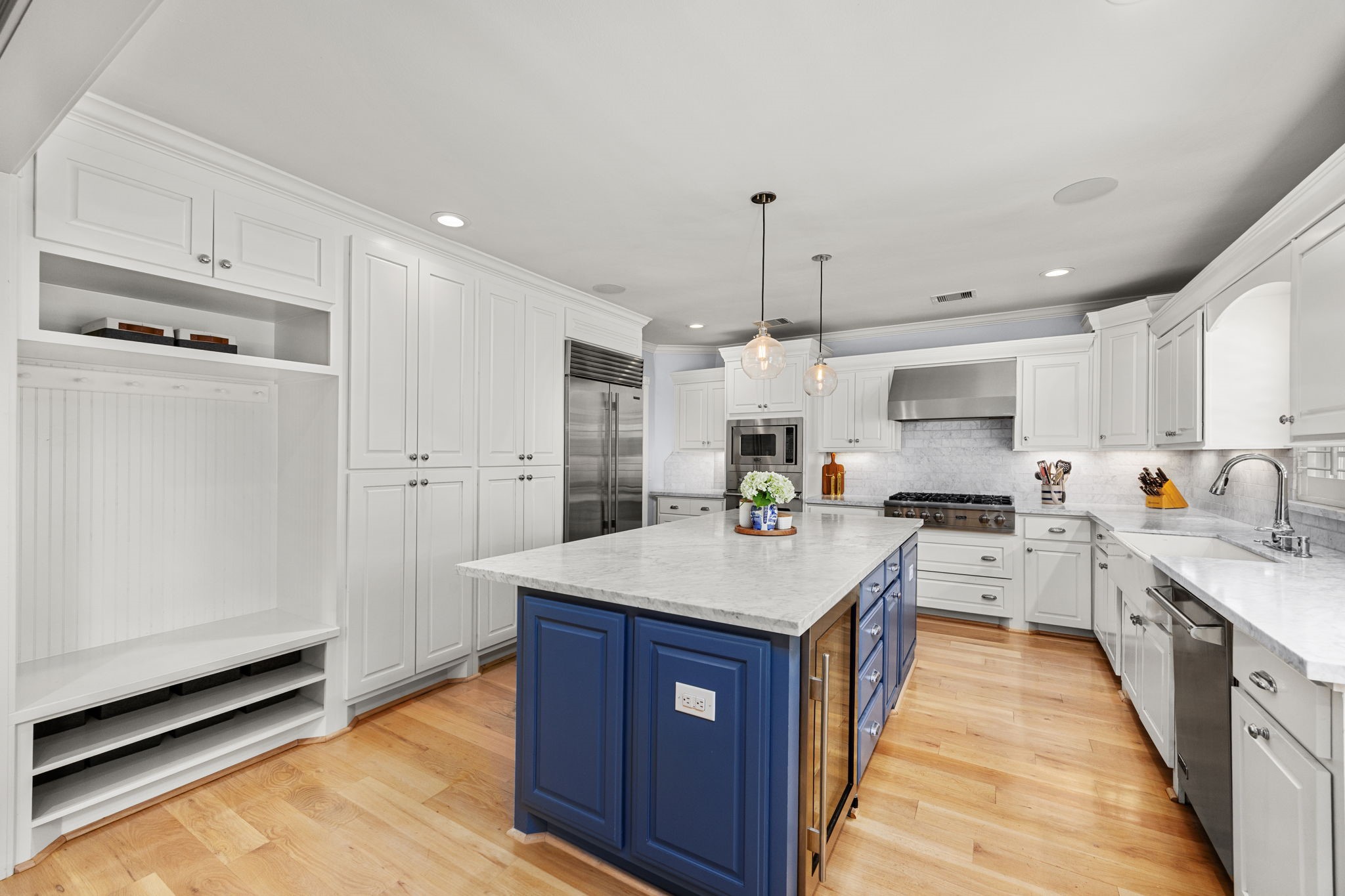 1741 Banks Street Houston, TX 77098 - Photo 13 of 50 a large kitchen with stainless steel appliances lots of counter space and wooden floor