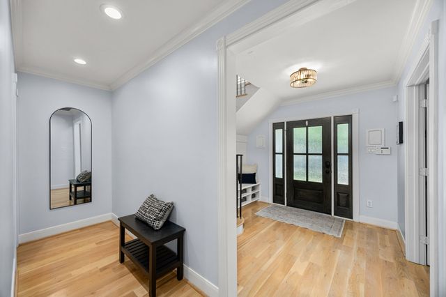 a bathroom with a granite countertop sink mirror vanity and toilet