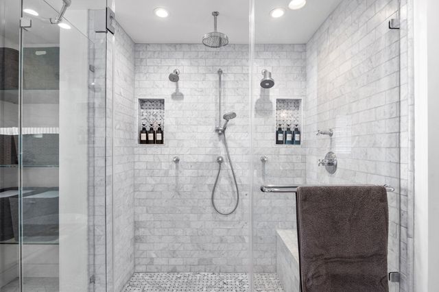 a spacious bathroom with a shower sink and mirror
