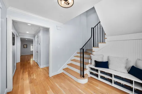 a view of entryway with wooden floor and stairs