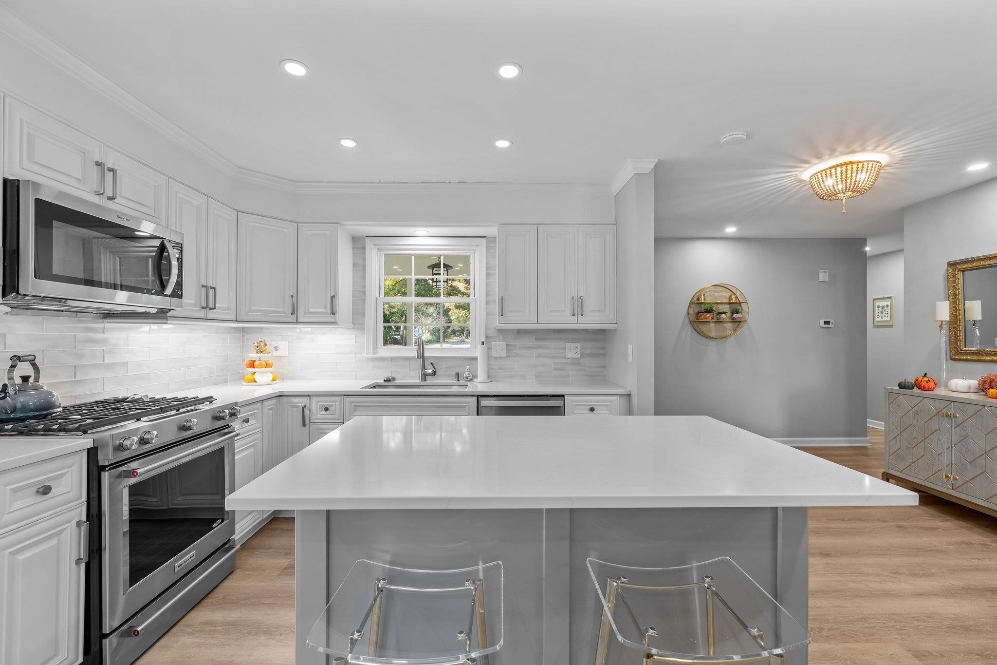 3604 Morningside Drive Raleigh, NC 27607 - Photo 11 of 38 a kitchen with stainless steel appliances a sink a stove a microwave a center island and cabinets