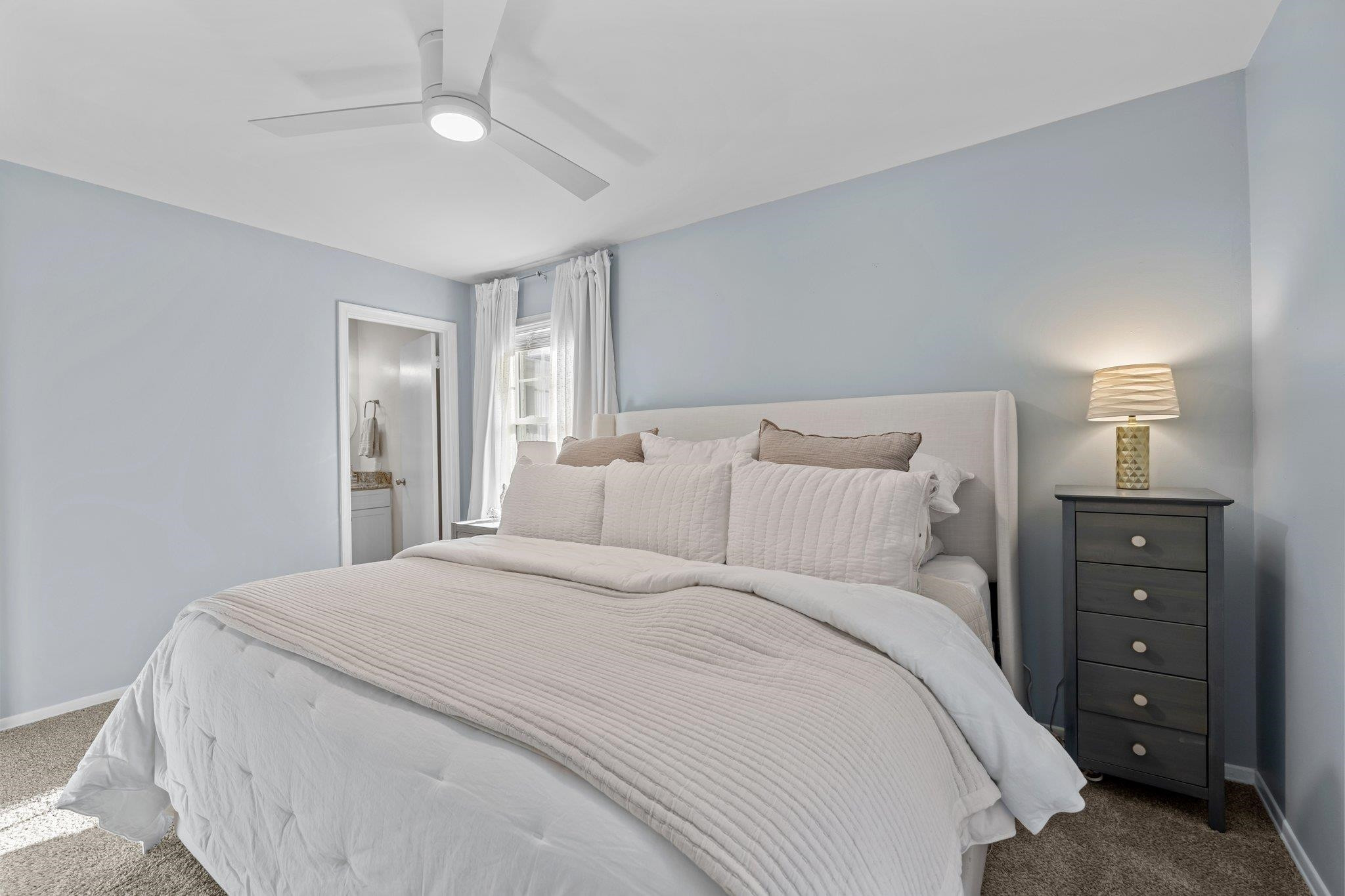 3604 Morningside Drive Raleigh, NC 27607 - Photo 30 of 38 a bedroom with a bed and a ceiling fan