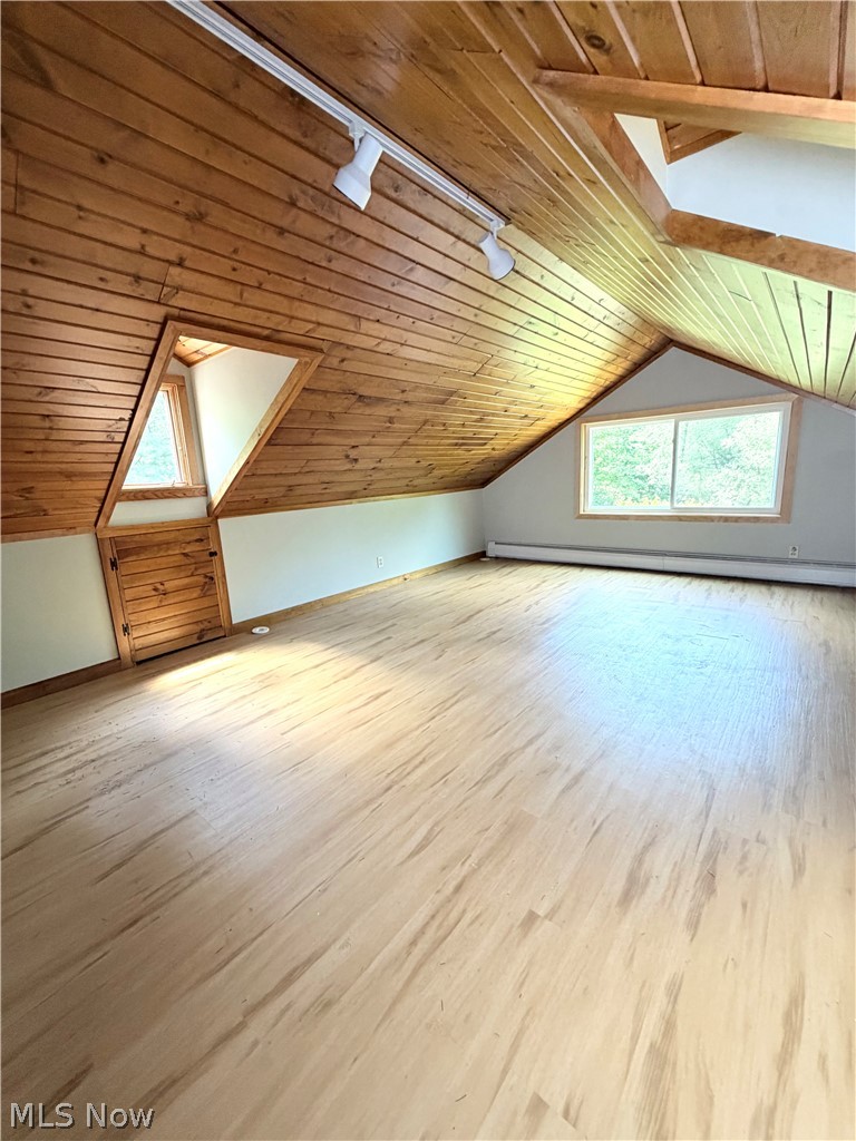 12590 Rockhaven Road Chesterland, OH 44026 - Photo 17 of 25 Spacious room featuring wood-finish flooring, wood plank ceiling, track lighting, and multiple windows