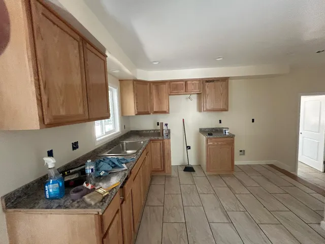 a utility room with cabinets washer and dryer