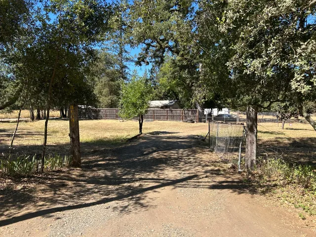 a kitchen with granite countertop a sink stove and cabinets