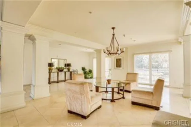 a living room with furniture and a chandelier