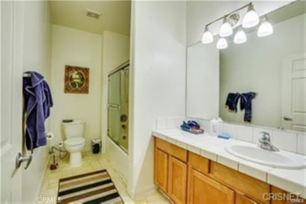 9610 Zelzah Avenue, Unit 310 Northridge, CA 91325 - Photo 11 of 32 a bathroom with a sink and a mirror