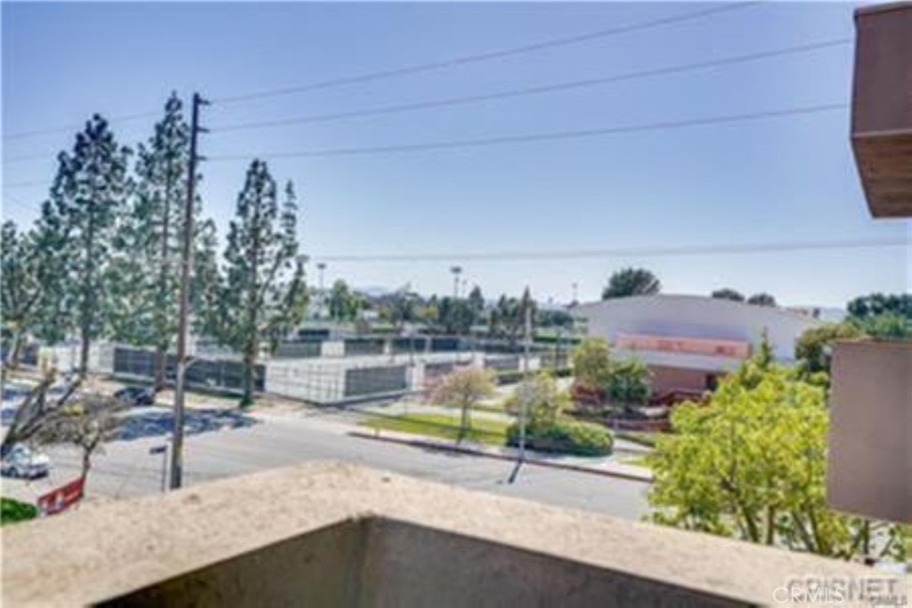 9610 Zelzah Avenue, Unit 310 Northridge, CA 91325 - Photo 13 of 32 a view of a swimming pool with a patio and a yard