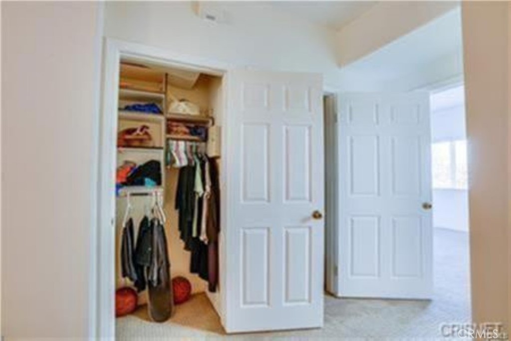 9610 Zelzah Avenue, Unit 310 Northridge, CA 91325 - Photo 15 of 32 a view of walk in closet with clothes