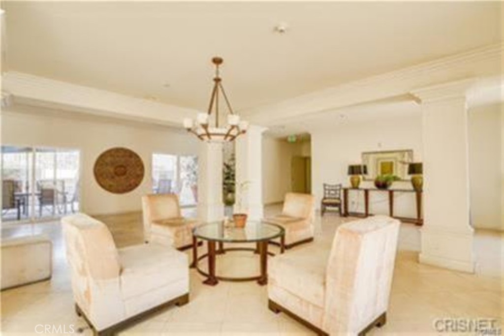 9610 Zelzah Avenue, Unit 310 Northridge, CA 91325 - Photo 18 of 32 a living room with furniture a chandelier and a window