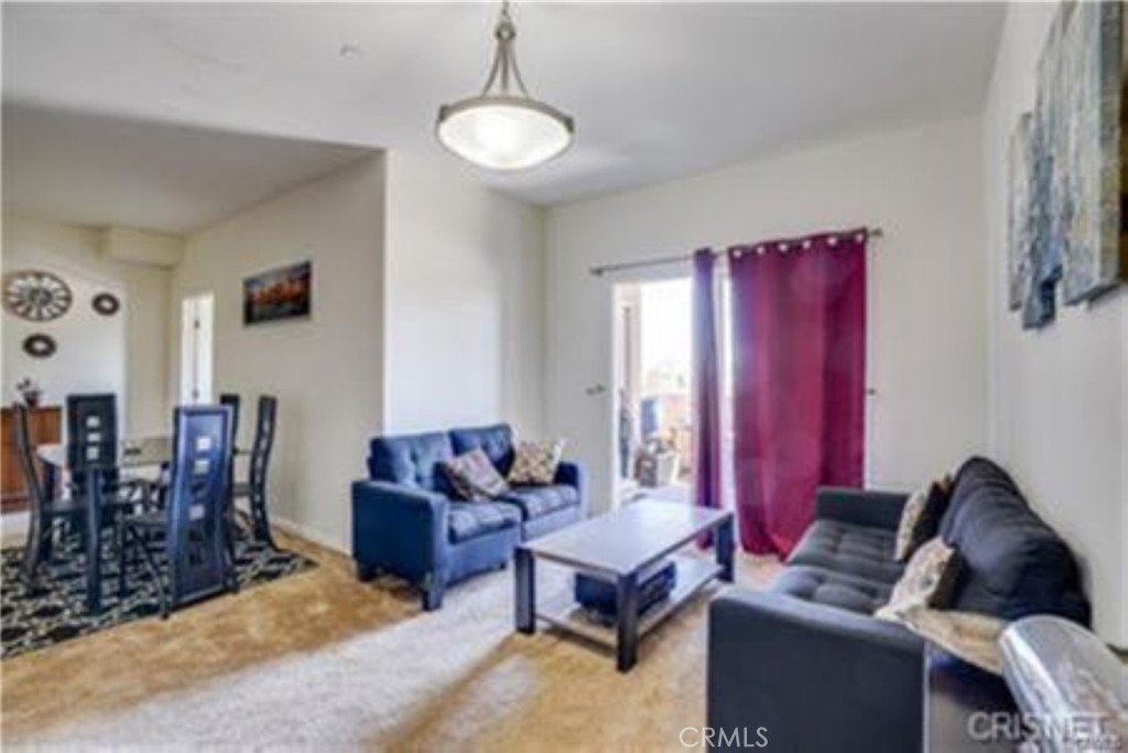 9610 Zelzah Avenue, Unit 310 Northridge, CA 91325 - Photo 5 of 32 a living room with furniture a flat screen tv and a window