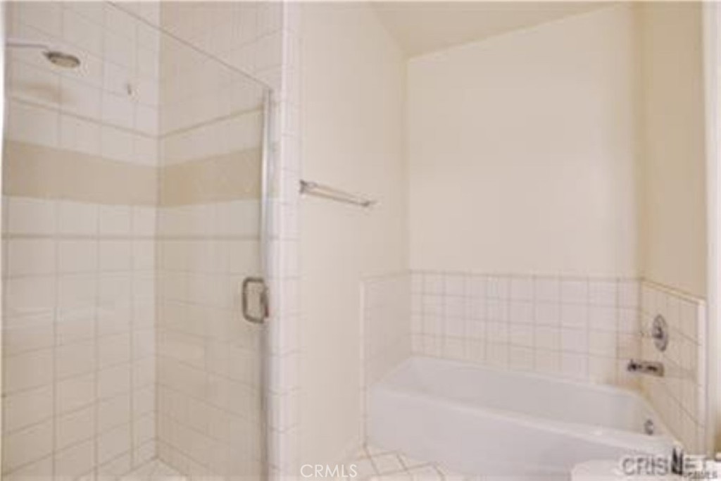 9610 Zelzah Avenue, Unit 310 Northridge, CA 91325 - Photo 10 of 32 a bathroom with a shower and a bath tub
