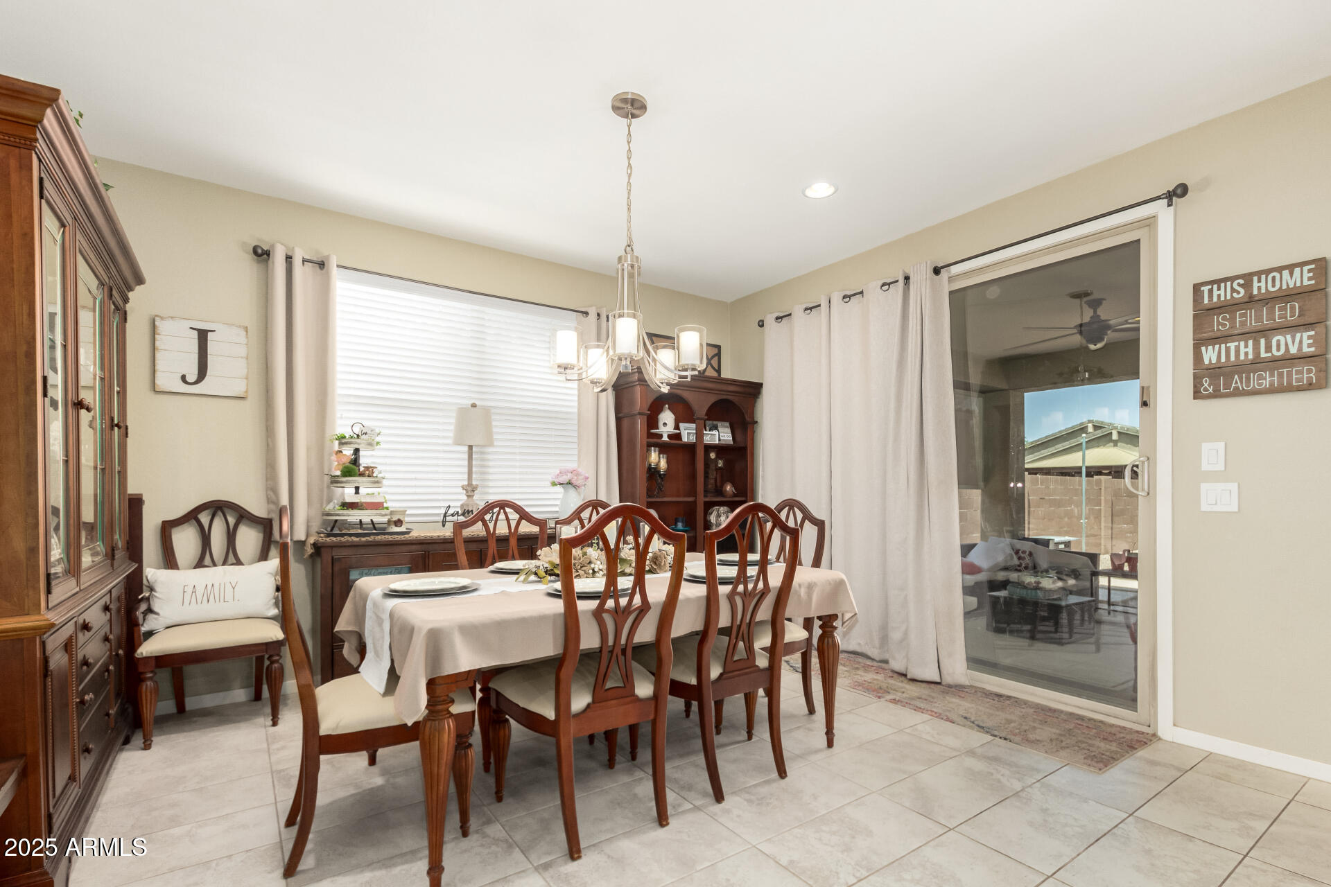 40098 West Ganly Way Maricopa, AZ 85138 - Photo 12 of 46 a view of a dining room and livingroom with furniture wooden floor a chandelier