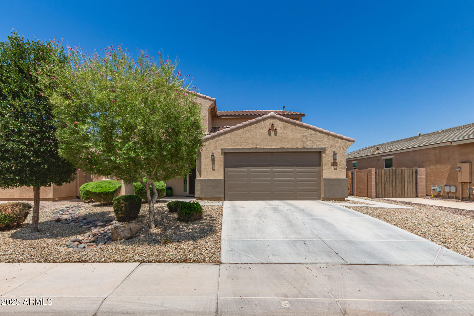 40098 West Ganly Way Maricopa, AZ 85138 - Photo 2 of 46 a front view of a house with garden