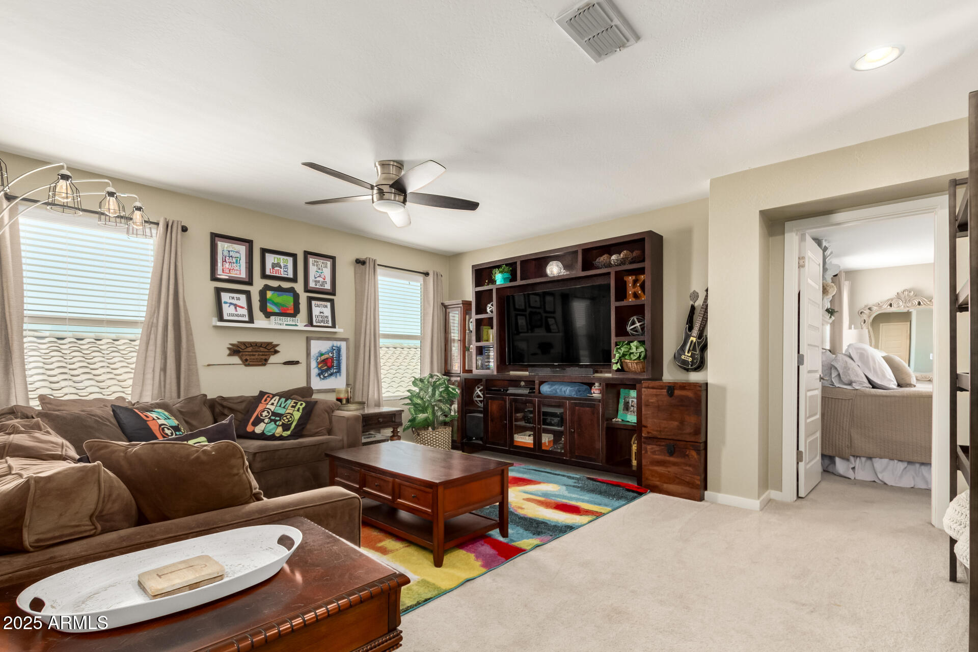 40098 West Ganly Way Maricopa, AZ 85138 - Photo 22 of 46 a living room with furniture a flat screen tv and a large window