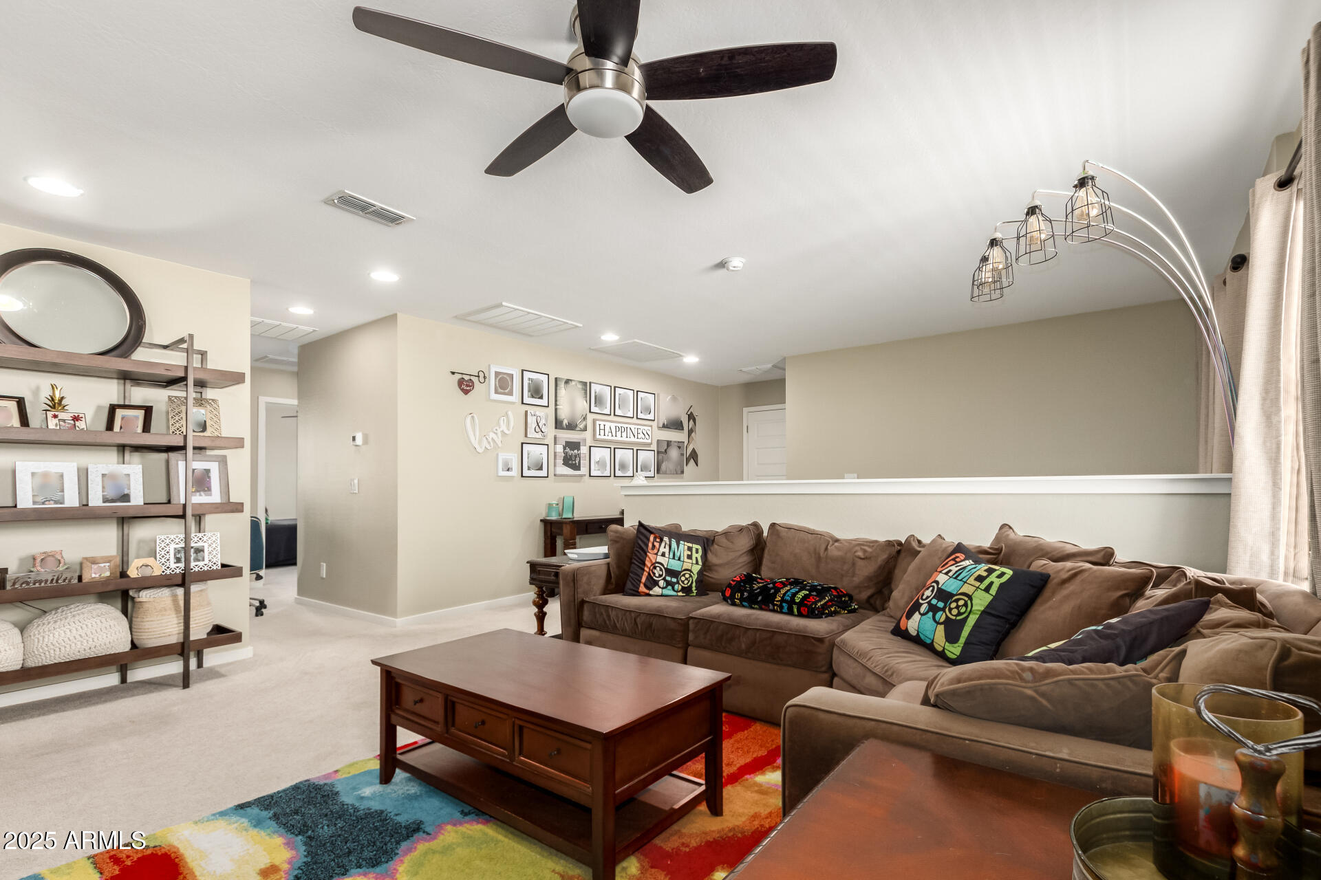 40098 West Ganly Way Maricopa, AZ 85138 - Photo 23 of 46 a living room with furniture a rug and white walls