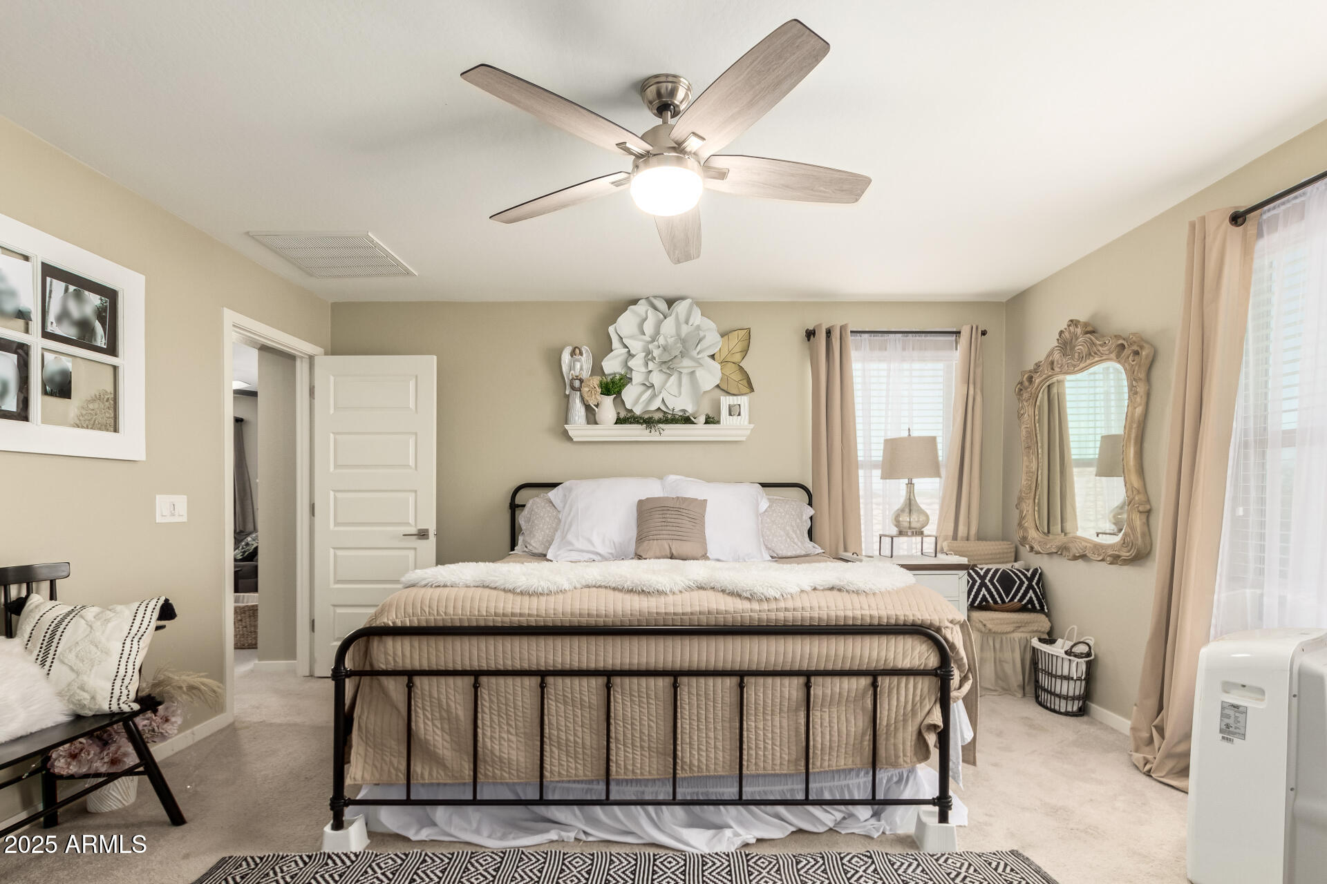 40098 West Ganly Way Maricopa, AZ 85138 - Photo 25 of 46 a bedroom with a large bed and a chandelier