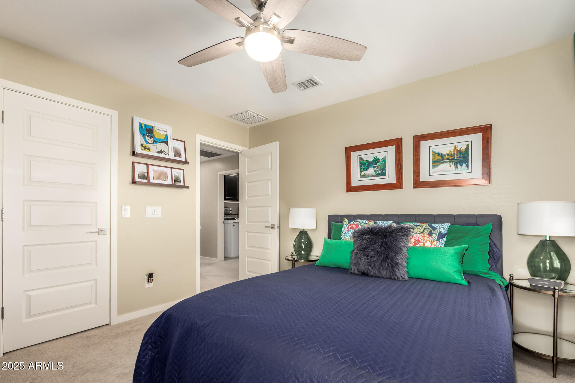 40098 West Ganly Way Maricopa, AZ 85138 - Photo 32 of 46 a bedroom with bed and a chandelier