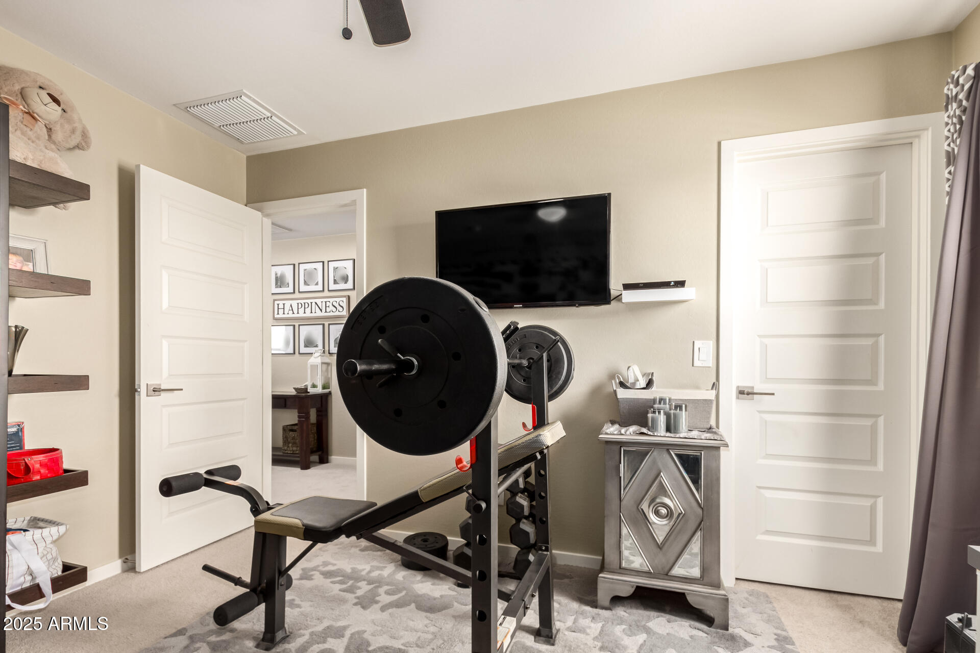 40098 West Ganly Way Maricopa, AZ 85138 - Photo 36 of 46 a view of a workspace with furniture and a flat screen tv