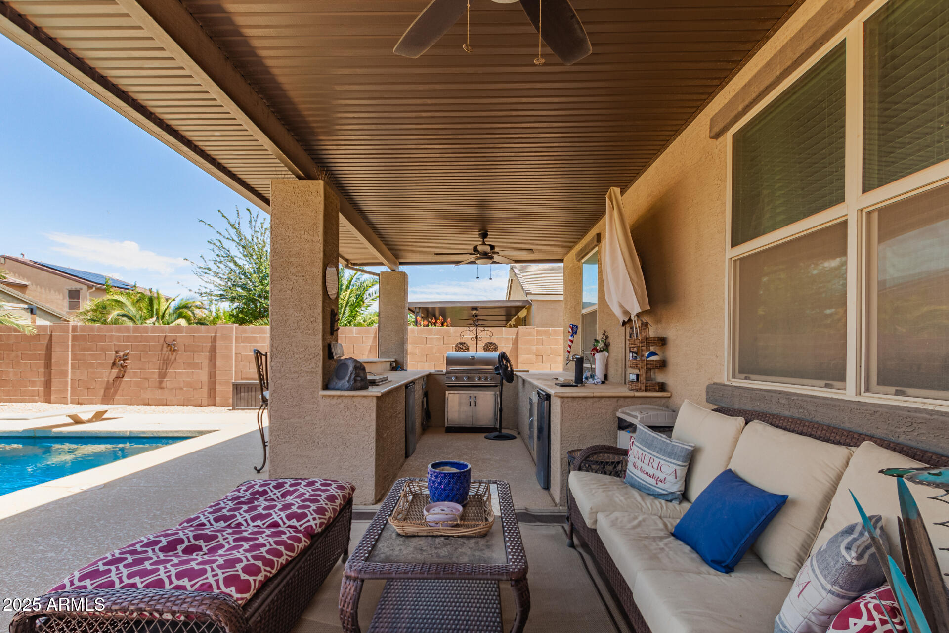 40098 West Ganly Way Maricopa, AZ 85138 - Photo 39 of 46 a living room with furniture and a floor to ceiling window