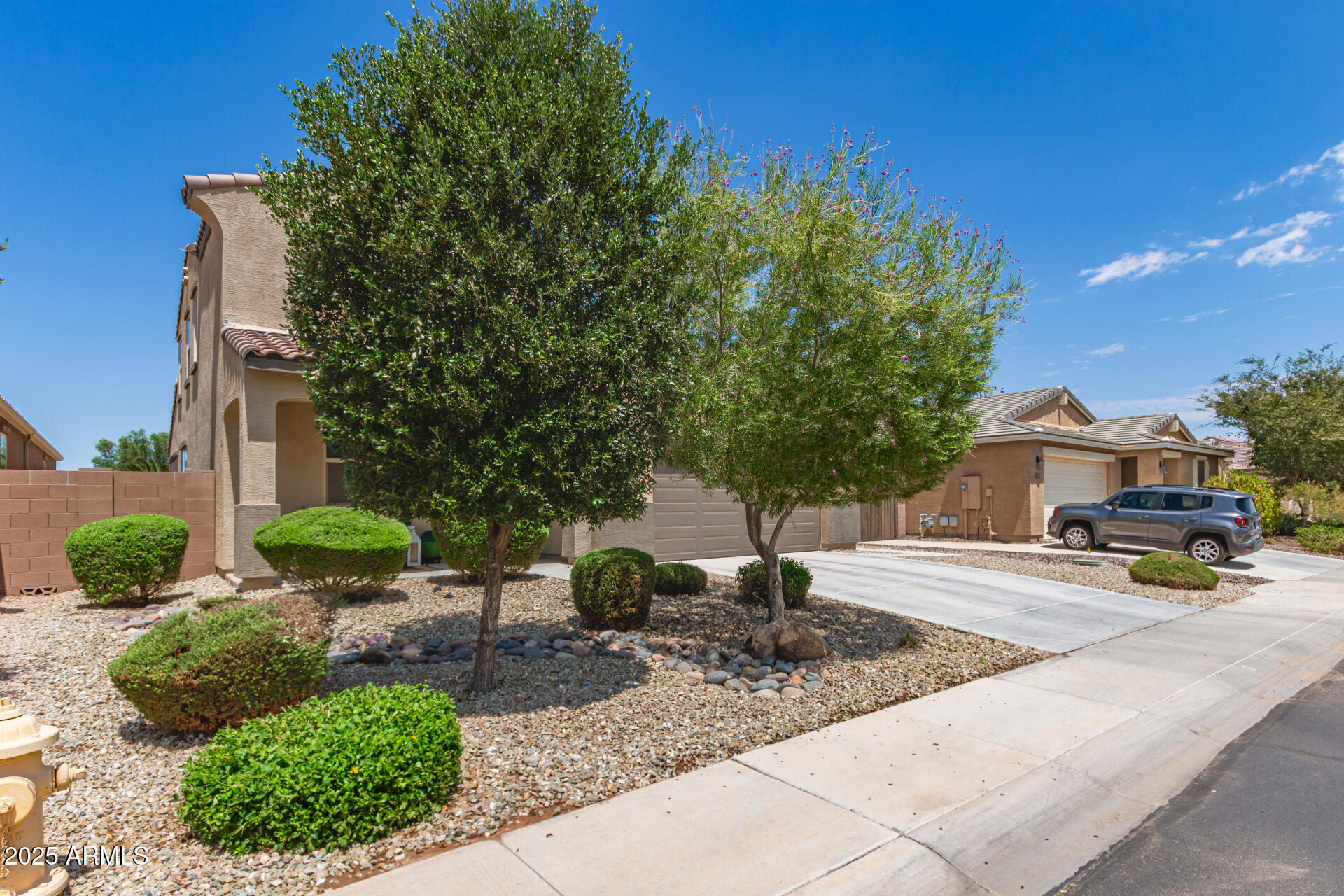 40098 West Ganly Way Maricopa, AZ 85138 - Photo 4 of 46 a view of a backyard with table and chairs under an umbrella