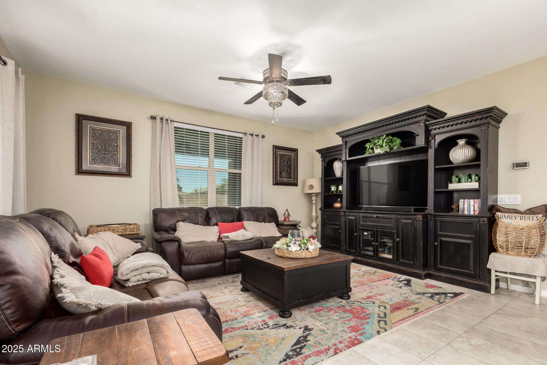 40098 West Ganly Way Maricopa, AZ 85138 - Photo 10 of 46 a living room with furniture and a flat screen tv