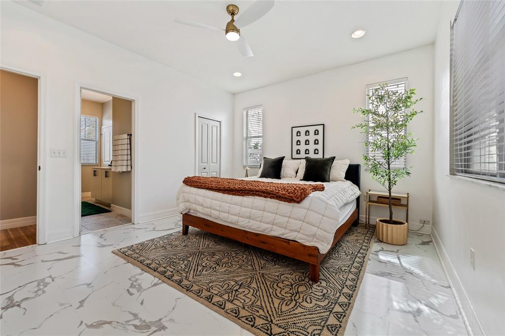 7935 Winter Wren Street Winter Garden, FL 34787 - Photo 18 of 36 a bedroom with a bed and a chandelier