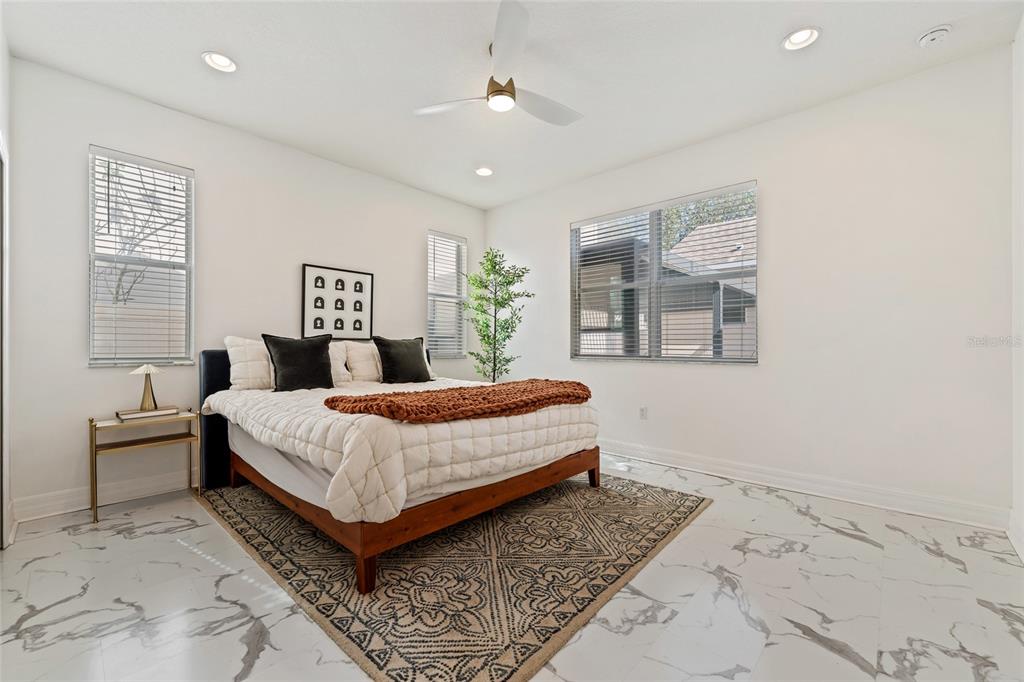 7935 Winter Wren Street Winter Garden, FL 34787 - Photo 19 of 36 a bedroom with a large bed and a painting on the wall