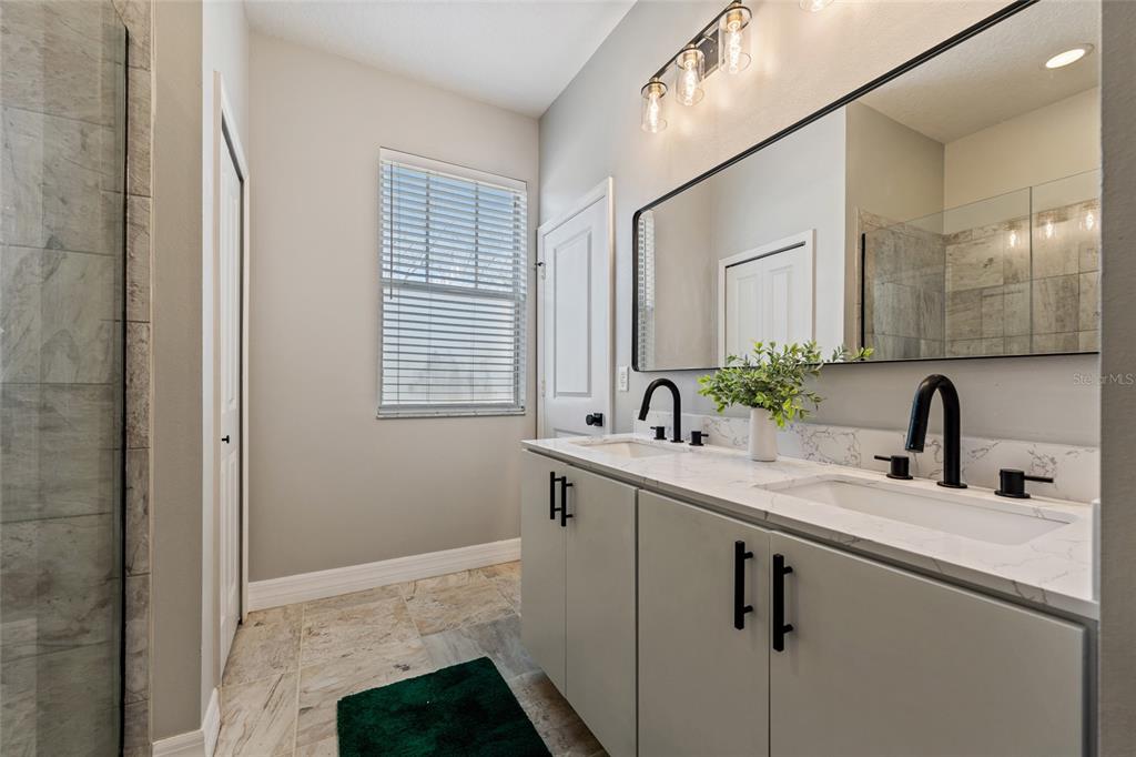 7935 Winter Wren Street Winter Garden, FL 34787 - Photo 20 of 36 a bathroom with a sink and a mirror