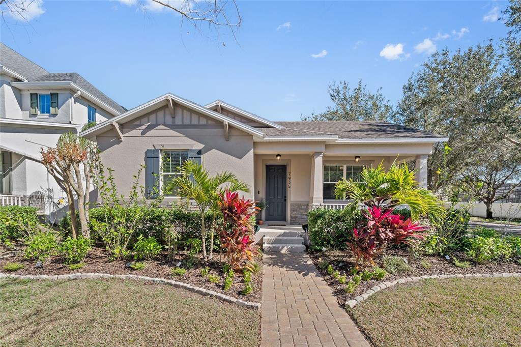 7935 Winter Wren Street Winter Garden, FL 34787 - Photo 2 of 36 a front view of a house with lots of flower plants