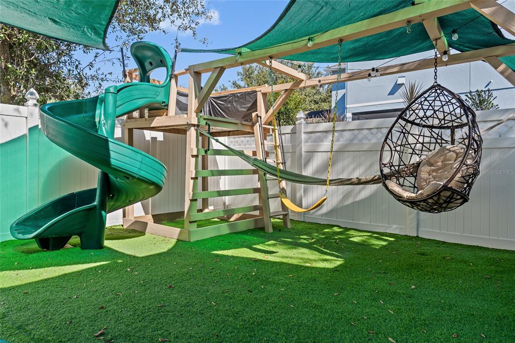7935 Winter Wren Street Winter Garden, FL 34787 - Photo 31 of 36 a view of an chair and table in the garden
