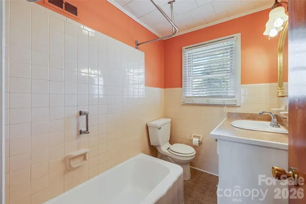 a bathroom with a sink a toilet and tub