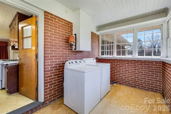 a view of a brick house with many windows
