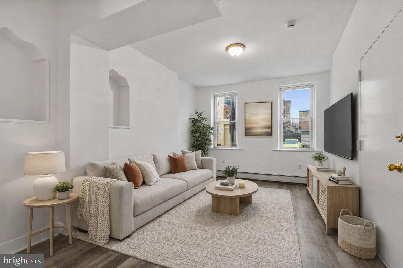 a living room with furniture and a flat screen tv