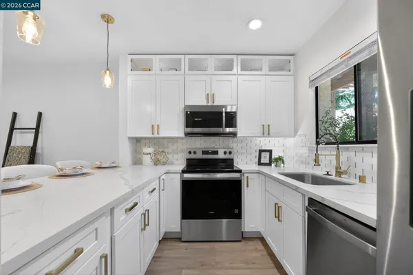 a kitchen with a sink stove and microwave
