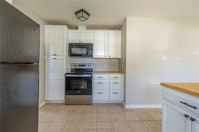 a kitchen with stainless steel appliances a stove and a refrigerator