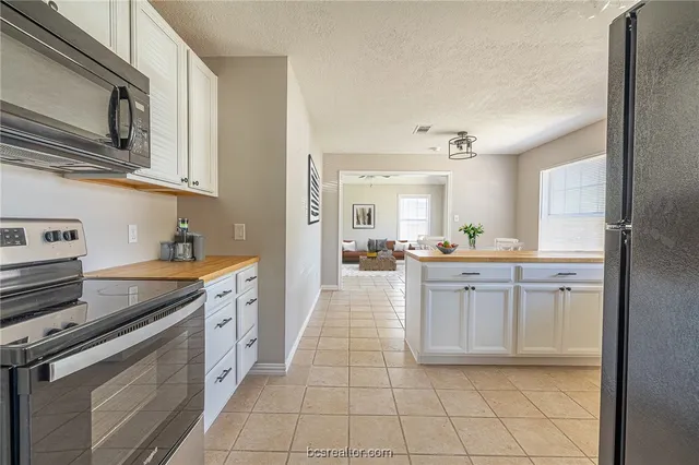 a kitchen with stainless steel appliances granite countertop a stove and a sink